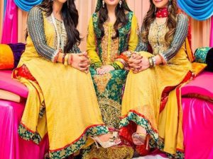 Girls sitting wearing their mehndi dress